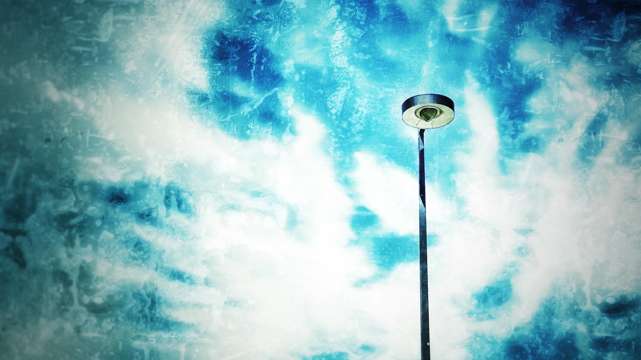A street light with a cloudy sky background