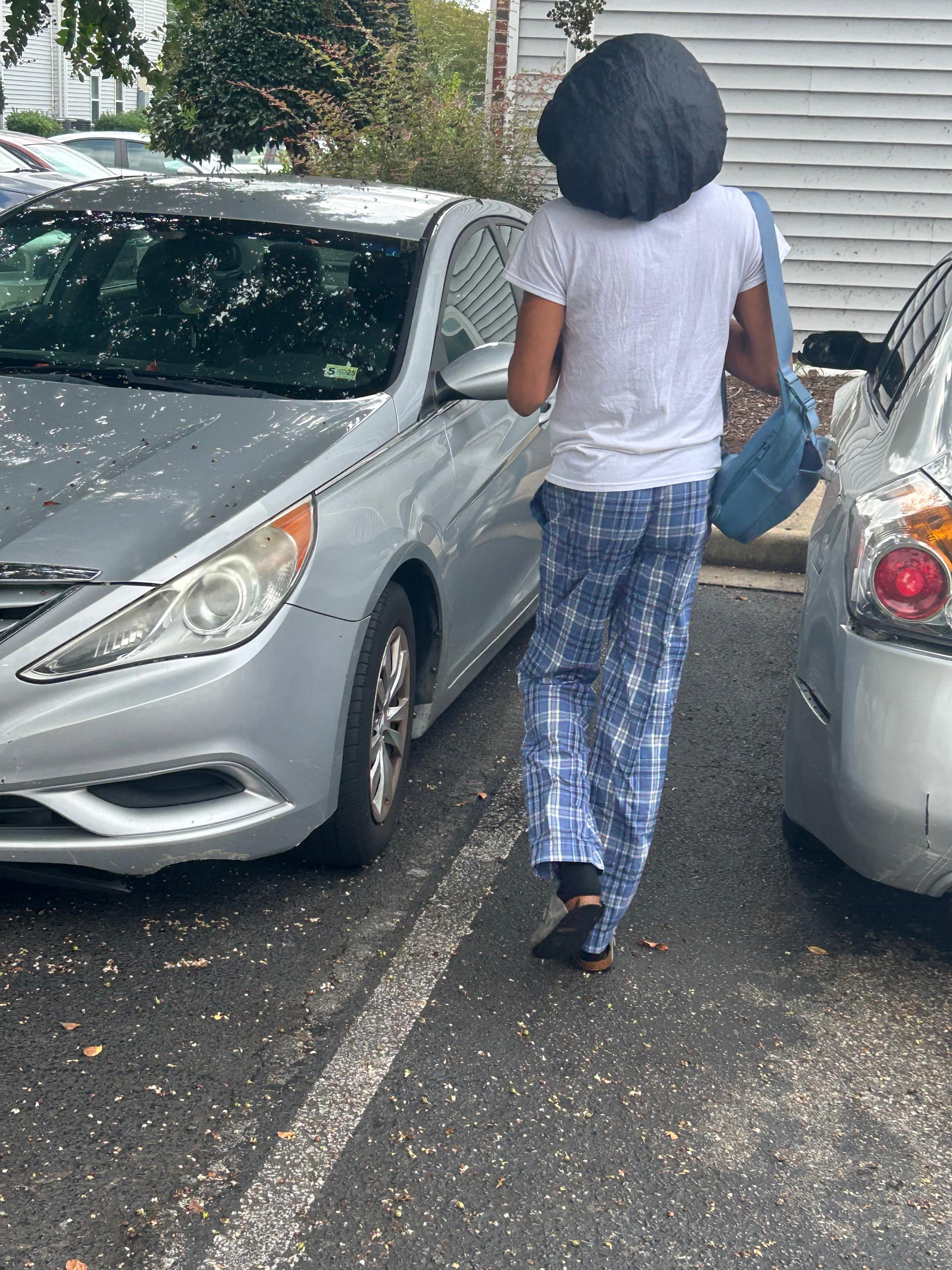 Keon was photographed walking toward his car while carrying a blue bag. Hampton, VA | August 29, 2026