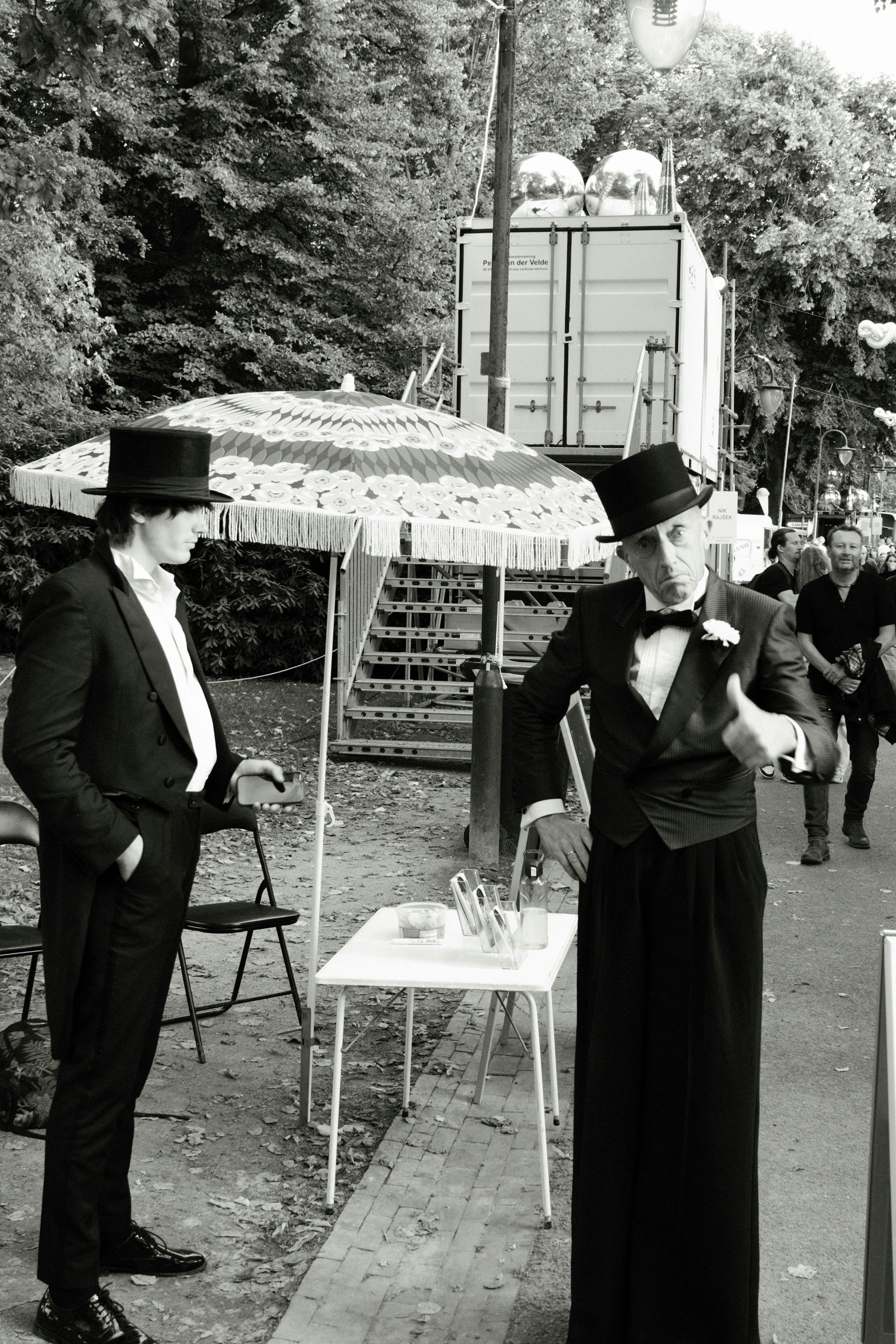 A b/w photo with two gentlemen dressed in 19th century clothes and high hats. They are performers at Noorderzon 2026.