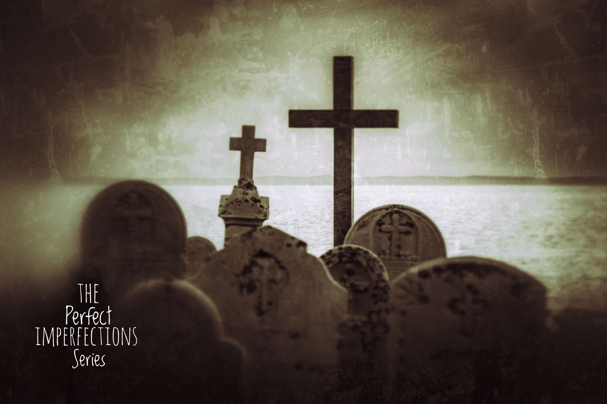 Tombstones with crosses on the top of two of them.